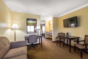a living room with a couch and a table and chairs at Quality Inn & Suites Bell Gardens-Los Angeles in Bell Gardens