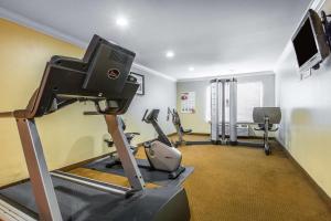 a gym with tread machines and a flat screen tv at Quality Inn & Suites Bell Gardens-Los Angeles in Bell Gardens