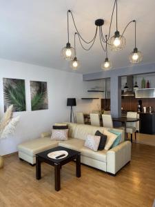 a living room with a couch and a table at Makas Apartamenty in Świnoujście +9 photos