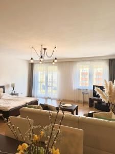 a living room with couches and a couch and a table at Makas Apartamenty in Świnoujście