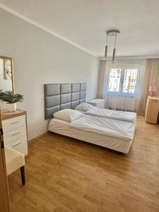 a bedroom with a large bed in a room at Makas Apartamenty in Świnoujście