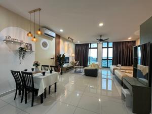 a living room with a couch and a dining room at Leisure Home-1Bedroom in Masai