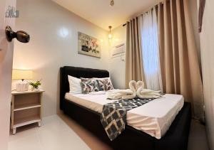 a small bedroom with a bed and a window at Family Getaway 2BR Rental Homes Near Palawan Airport - B2 4Kunzite in Puerto Princesa City +150 photos
