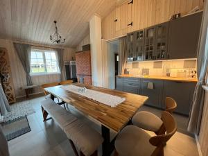a kitchen with a wooden table and chairs at Pirties namelis Paliekys in Lekėčiai