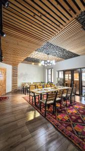 a large dining room with wooden tables and chairs at Kezgin Guest House in Naryn