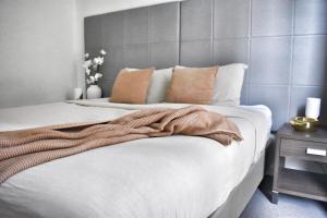 a bedroom with a bed with a blanket on it at Banksys Hideout London Graffiti-Style Apartment in Brisbane