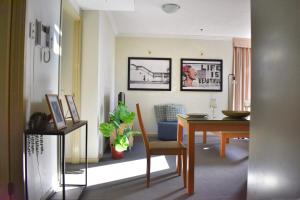 a living room with a table and a dining room at Banksys Hideout London Graffiti-Style Apartment in Brisbane