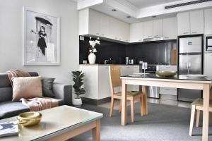a kitchen and living room with a couch and a table at Banksys Hideout London Graffiti-Style Apartment in Brisbane