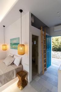 a bedroom with a bed and a ladder and a staircase at Ammos Studio Pyrgaki Naxos in Agiassos +28 photos