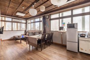 a kitchen and dining room with a table and chairs at 地域最大級 ビル2フロア完全貸切最大15名 国際通り徒歩1分 2台駐車場無料 リラックスした雰囲気 Paradise inn 安里 in Naha