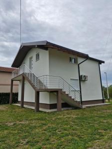 a house with a staircase on the side of it at Knežević apartman in Podgorica
