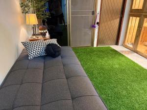 a patio with a green lawn in a house at cat hotel hatyai cat only in Hat Yai
