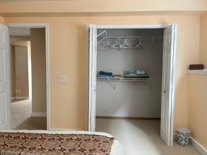 a bedroom with a door open to a closet at citadle hill house! in Calgary