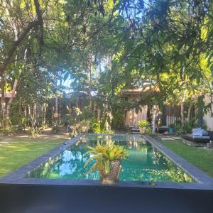 a swimming pool in the backyard of a house at A CASA DO CRIADOR HOTEL BOUTIQUE in Arraial d'Ajuda