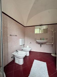 a bathroom with two toilets and a sink and a mirror at CASA BACICCIA in Badalucco +33 photos