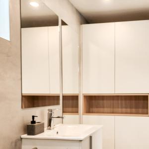a bathroom with a sink and white cabinets at Freedom Tiny Homes Resort in East London