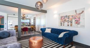 a living room with a blue couch and a dining room at Villa Vitovlje in Vitovlje +14 photos
