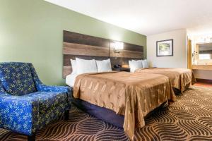a hotel room with two beds and a chair at Quality Inn Black Mountain-Asheville East in Black Mountain +33 photos