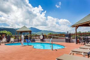a pool at a resort with chairs and tables at Quality Inn Black Mountain-Asheville East in Black Mountain