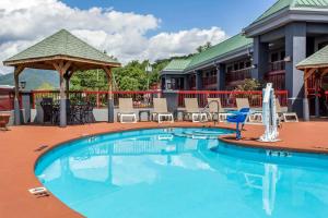 a pool at a resort with chairs and a gazebo at Quality Inn Black Mountain-Asheville East in Black Mountain