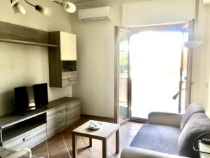 a living room with a couch and a tv at Casa Mare Verde in Casamicciola Terme