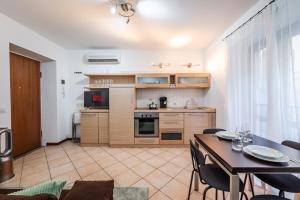 a kitchen and dining room with a table and chairs at Milan Navigli Darsena - In City Center - AC in Milan