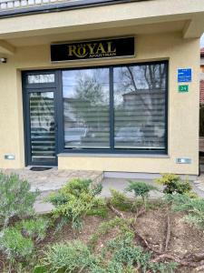 a ryuani store front with a sign in the window at Apartman ROYAL in Sanski most