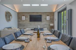 a dining room with a table and a couch at The Retreat Luxury Coastal Villa near Sandringham Crabpot Cottages Hunstanton in Dersingham