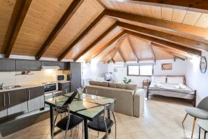 a kitchen and living room with a couch and a table at Esperides Luxury Suites 3 in Kalamitsi