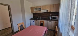 a small kitchen with a table and a microwave at Relax House Samardzic in Ličko Petrovo Selo +30 photos