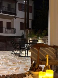 a patio with chairs and a table and a building at Olympus Stone Lodge in Litochoro