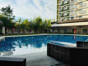 a large swimming pool in front of a building at 1 Bedroom Unit In Bamboo Bay in Mandaue City