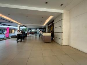 a lobby of a building with people sitting at tables at 1 Bedroom Unit In Bamboo Bay in Mandaue City