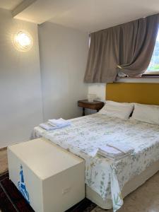 a bedroom with a bed and a window and a box at LightHouse in Albissola Marina
