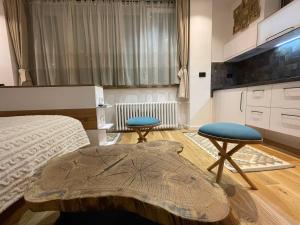 a bedroom with a bed and two stools in it at Tiny Nest - Sava Center, Belgrade in Belgrade +17 photos