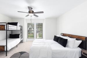 a bedroom with two beds and a ceiling fan at Modern Comfort Near AU l Perfect for Families & Fans in Auburn