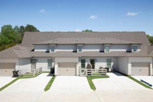 a large house with a large driveway at Modern Comfort Near AU l Perfect for Families & Fans in Auburn