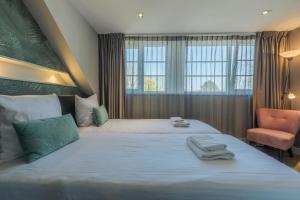 Postel nebo postele na pokoji v ubytování B&B Dennenbos