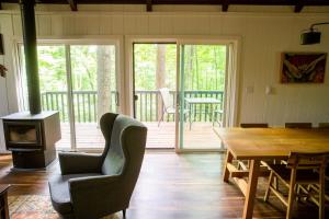 a living room with a table and a wood stove at Trillium Ridge, Hocking Hills Area, 2 Bedroom, 3 Beds in Rockbridge