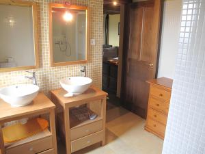 a bathroom with two sinks and a mirror at Casa con impresionantes vistas in Villar +29 photos