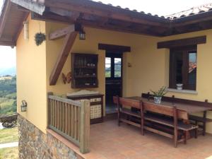 a patio with a table and benches on a house at Casa con impresionantes vistas in Villar