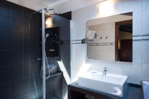 a bathroom with a sink and a shower with a mirror at Phi Hotel Bologna in Bologna +111 photos