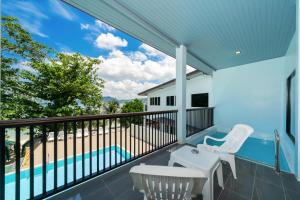 a balcony with a view of a swimming pool at The Hideout Beachfront in Patong Beach