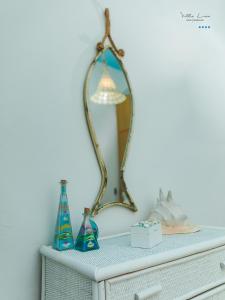 a mirror on top of a dresser in a room at Villa Lina in Castiglioncello