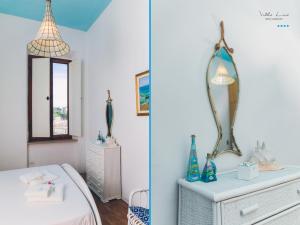 a bedroom with a white dresser and a mirror at Villa Lina in Castiglioncello