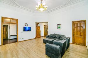 a living room with a couch and a tv at Apartment AERİA in Baku