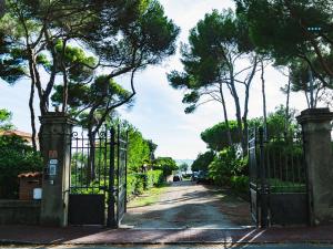 an entrance to a driveway with a wrought iron gate at Villa Lina in Castiglioncello