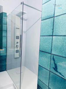 a shower with a glass door with a dolphin in it at Villa Lina in Castiglioncello