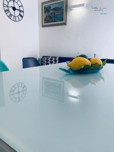 a table with a plate of fruit on it at Villa Lina in Castiglioncello