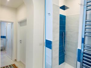a bathroom with a shower with blue and white tiles at Villa Lina in Castiglioncello
